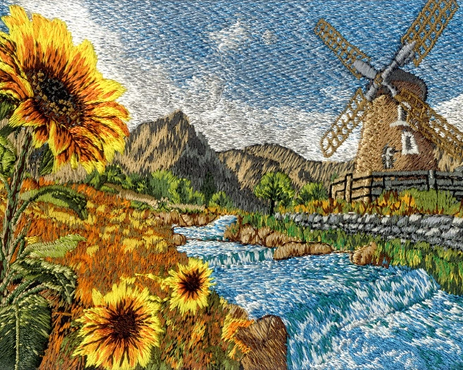 Detailed machine-embroidered landscape featuring bright sunflowers, a rushing stream, mountains, and a stone windmill.