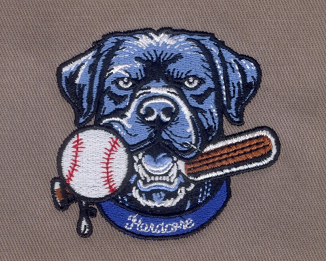 Embroidered patch of a blue bulldog logo holding a baseball bat in its mouth next to a baseball.